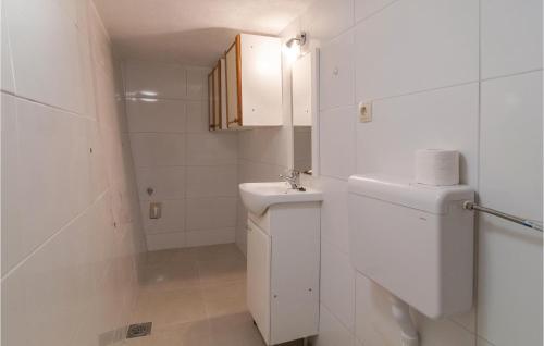 オミシュにあるNice Apartment In Omis With Wifiの白いバスルーム(洗面台、トイレ付)