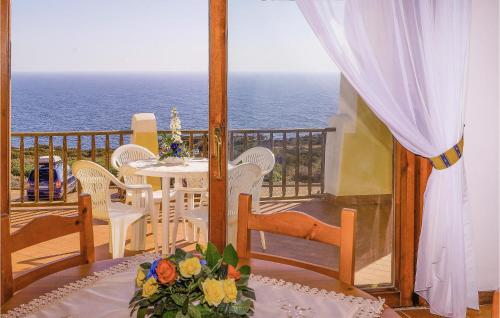 a balcony with a table and chairs and the ocean at Bilo 4 in Cuile Pazzoni