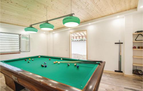 a pool table in a living room with at Gorgeous Home In Sant'angelo Romano in SantʼAngelo Romano