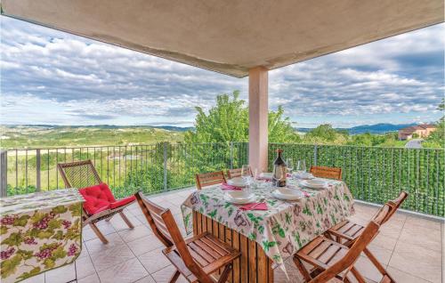 a table and chairs on a patio with a view at Villa Bellavista in Lequio Tanaro