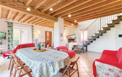 a dining room with a table and red chairs at Villa Bellavista in Lequio Tanaro