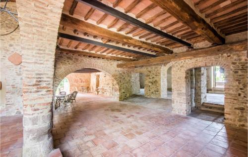 a large room with a brick wall and a ceiling at Materno 4 in Radicondoli