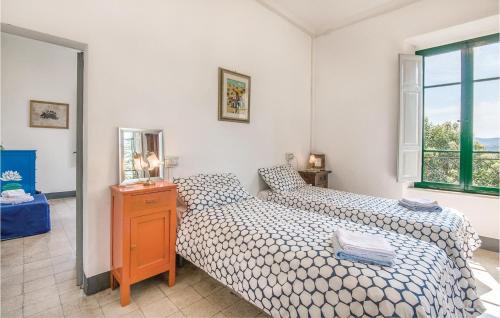 a bedroom with two beds and a mirror at Casa Del Picchio in Monte Castello di Vibio
