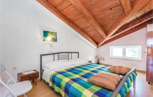 a bedroom with a bed and a wooden ceiling at Nice Apartment In Rab With Kitchen in Rab