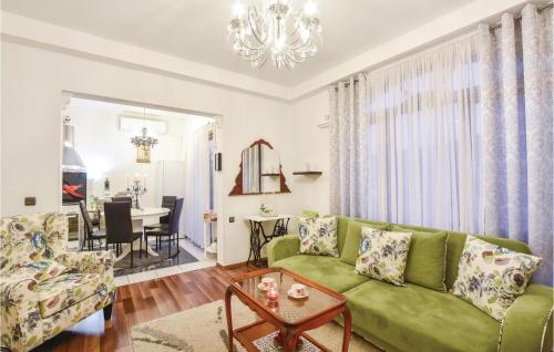 a living room with a green couch and a table at Cozy Home In Srinjine in Srinjine