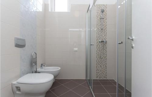 a bathroom with a shower and a toilet and a sink at 4 Bedroom Cozy Home In Vodnjan in Vodnjan