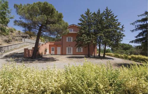 an orange house with trees in front of it at Villa Margherita in Poggioni