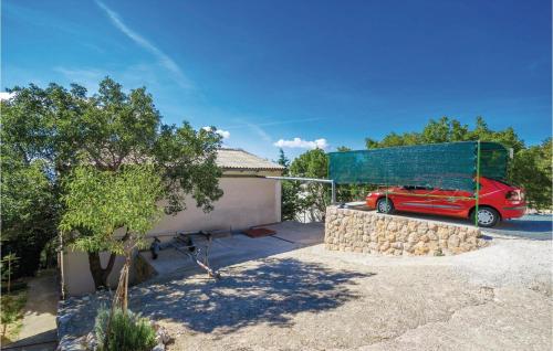 a red car parked in front of a garage at Holiday Home Baric Draga Baric Draga in Barić Draga