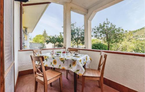 a table and chairs on a balcony with a window at Gorgeous Apartment In Castellabate Sa in Castellabate