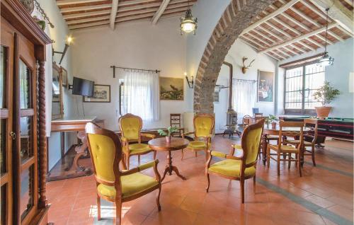 a living room with a table and chairs and a piano at Castello Rocchette in Celleno