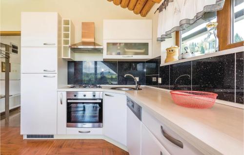 a white kitchen with white cabinets and a sink at 3 Bedroom Nice Home In Moravice in Moravice