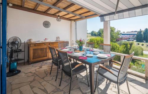 a dining room with a table and chairs on a patio at Four-Bedroom Holiday Home In Vrsar in Vrsar