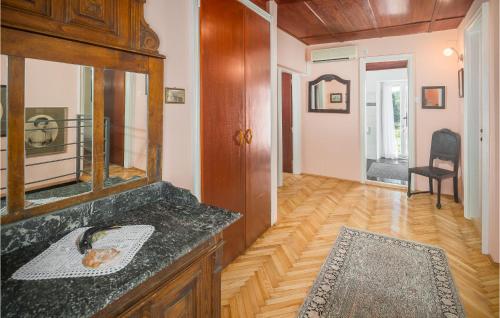 a bathroom with a sink and a mirror at Four-Bedroom Holiday Home In Vrsar in Vrsar