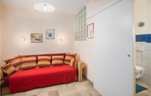 a bedroom with a red bed with pillows at Four-Bedroom Holiday Home In Vrsar in Vrsar