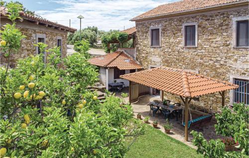 an outside view of a house with an umbrella at Awesome Apartment In Castellabate Sa in Castellabate