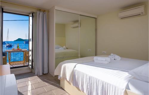 a bedroom with a bed and a view of the ocean at Nice Home In Lopud With 4 Bedrooms And Wifi in Lopud