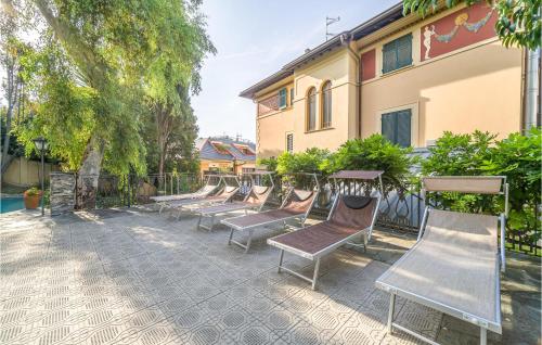 a row of chairs sitting next to a building at Mimosa in Rapallo