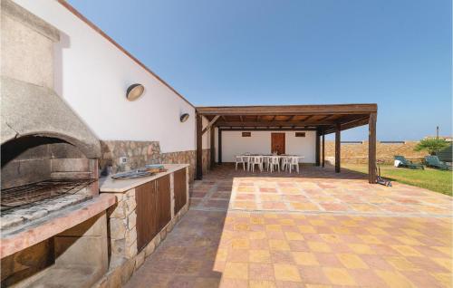 an outdoor kitchen and dining area with a pizza oven at Villa Mucera in Ficarazzi