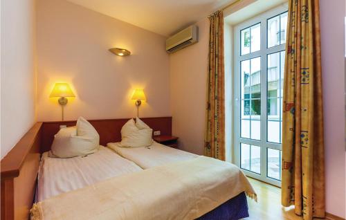 a bedroom with a bed and a large window at Awesome Apartment In Crikvenica With Wifi in Crikvenica