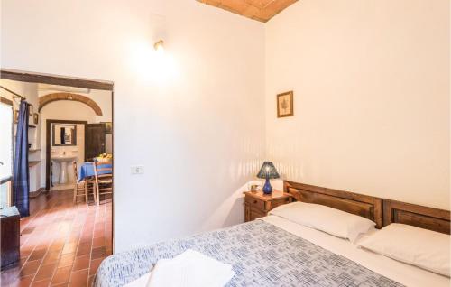 StradaにあるBeautiful Apartment In Castiglione D,lago Pg With 1 Bedrooms, Wifi And Outdoor Swimming Poolのベッドルーム1室(ベッド1台、ランプ付きテーブル付)