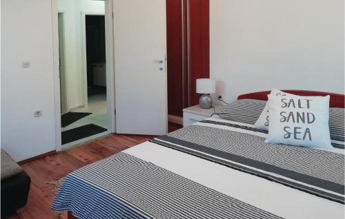 a bedroom with two beds with a salt and sea pillow at 2 Bedroom Awesome Apartment In Ston in Ston