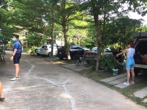 two people standing in a parking lot next to a truck at Nunou Cafe in Ban Than Lao