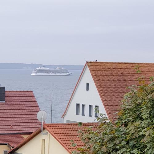 a cruise ship in the water with roofs at Villa Rosalie Sassnitz in Sassnitz