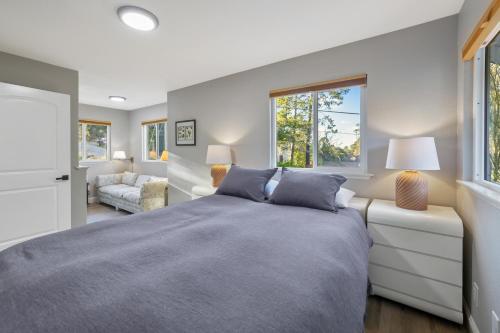 a bedroom with a bed and a living room at Wanderlust Cambria Seaside Village in Cambria