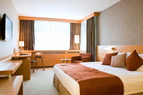 Ένα ή περισσότερα κρεβάτια σε δωμάτιο στο Hotel Tunali