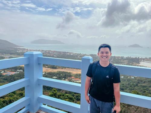 a man standing on the top of a white fence at Eden House & Coffee Con Dao in Con Dao