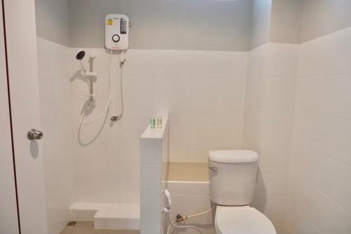 a bathroom with a toilet and a phone on the wall at โรงแรมคอมม่อนเวลธ์ Commonwealth Hotel&Resort in Suan Phung
