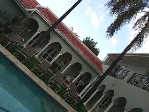 a building with chairs and a swimming pool at 131 on Herbert Baker Boutique Hotel in Pretoria