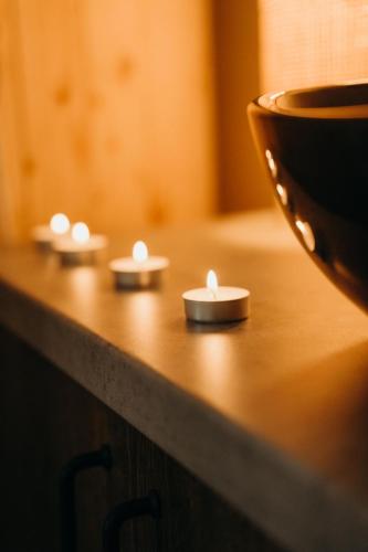a table with three candles on top of it at Hotel & Spa DENINNA in Vinnytsya