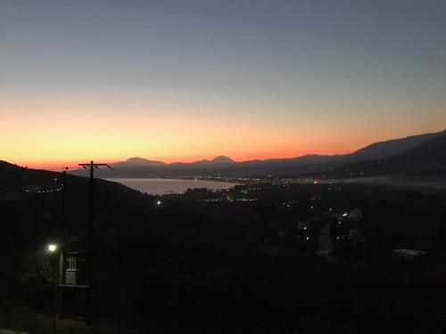 a sunset over a city and a body of water at Arbutus - Relaxing apartment with Fantastic Views in Georgioupolis