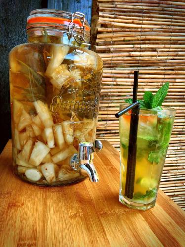 a jar of pickles and a drink on a table at Hotel L'Océan in Le Bois-Plage-en-Ré