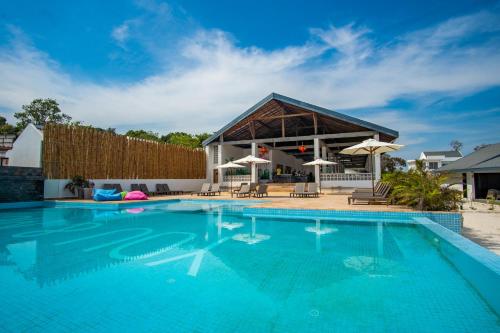 a swimming pool in front of a house at You&Me Resort in Koh Rong Island