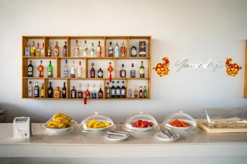 a shelf with bottles and bowls of food on a counter at You&Me Resort in Koh Rong Island