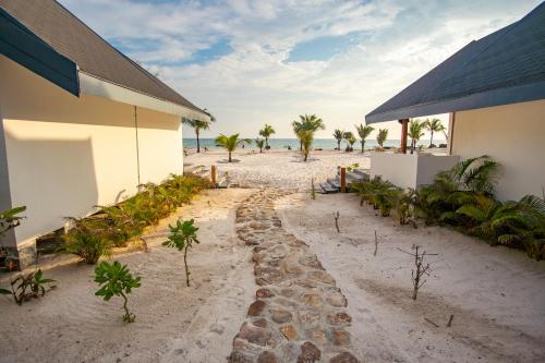 a walkway on the beach next to a building at You&Me Resort in Koh Rong Island