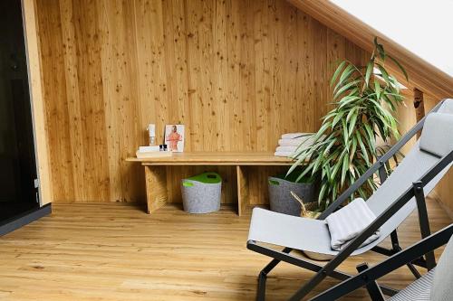 a wooden room with a table and a chair at Vis Saar Vie - Ferienwohnungen an der Saarschleife in Mettlach