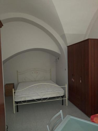 a bedroom with a bed and a cabinet and a table at Monolocale Foggia Centro in Foggia