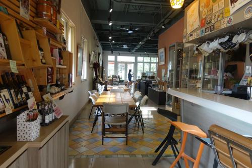 a restaurant with a long table and chairs at Read to Sleep Book & Bed in Puli