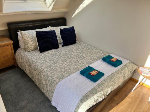 a bedroom with a bed with two towels on it at Stonehenge Campsite & Glamping in Berwick Saint James
