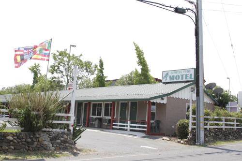 a small building with a sign for a motel at Jumping Frog Motel in Angels Camp