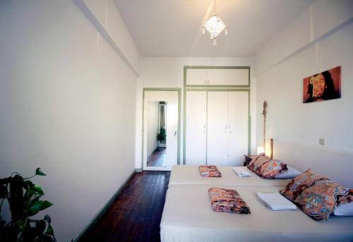 a white room with two beds in it at Lima Sol House in Limassol