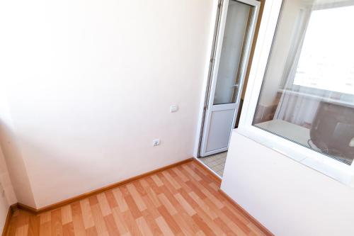 an empty room with a door and a window at Центр! Красноармейский 69б-13 in Barnaul