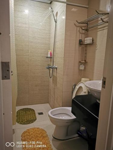 a bathroom with a shower and a toilet and a sink at Entire Home @150NB pasay city in Manila