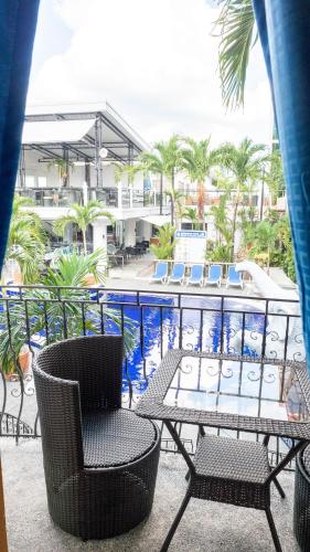 a patio with a table and chairs and a pool at Clarkton Hotel Apartment in Angeles