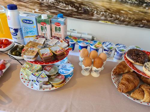 a table with plates of food and eggs and bread at Guest house Slatki Snovi in Knin
