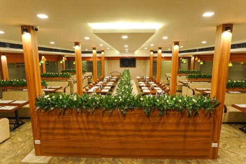 a large dining room with a long table at Sunstar Residency & Food Plaza Pala in Lālam