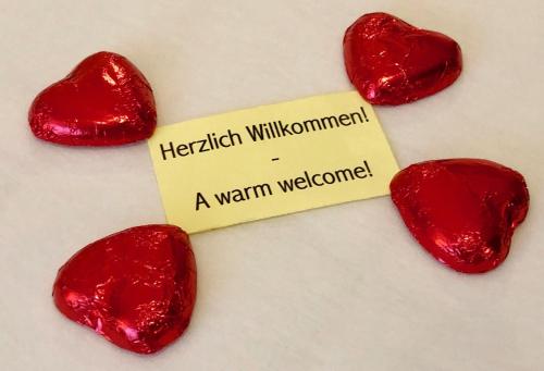 a wooden cross with two red hearts and a sign at Wonderful & Private Room with en-suite bathroom in Triesenberg